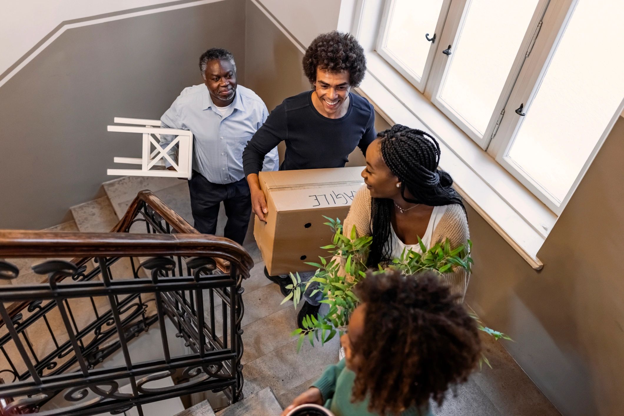 Professional movers carrying boxes