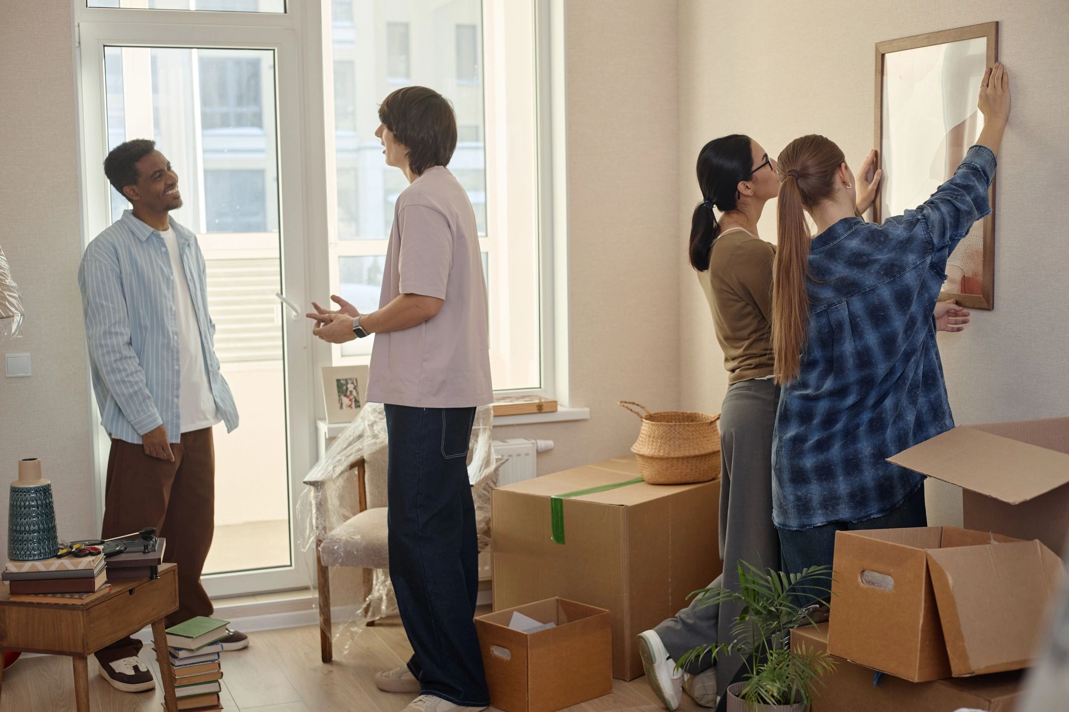 People unpacking boxes in a new home after moving
