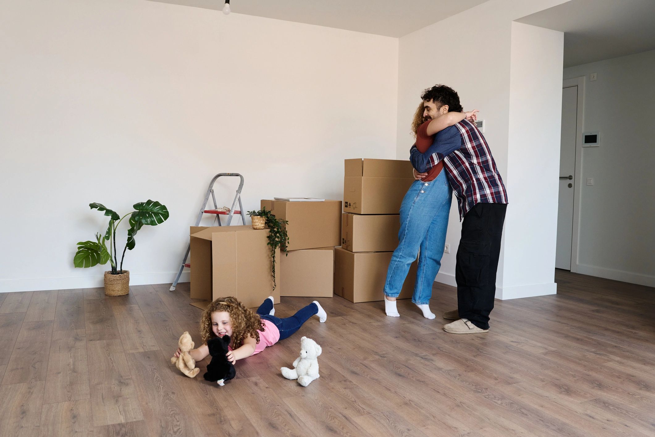 Family surrounded by boxes in a new home